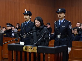 This handout picture taken on February 9, 2018 and released by the Hangzhou Intermediate People's Court shows defendant Mo Huanjing (C) listening to her sentence in the court in Hangzhou in China's eastern Zhejiang province.