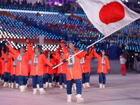 Flag bearer Noriaki Kasai leads Japan's delegation during the opening ceremony at the 2018 Winter Olympics in Pyeongchang.