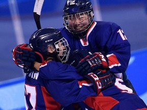 Unified Korea's Randi Griffin, left, celebrates with Kim Heewon after Griffin scored a goal in the women's game against Japan on Feb. 14, 2018.