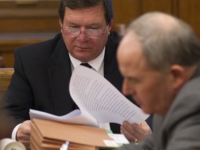 FILE - In this, Thursday, Jan. 12, 2012, file photo, David Holloway, left, looks over papers as he sits with his attorney Mark White during a probate hearing in Birmingham, Ala. The father of Natalee Holloway,  missing in Aruba since 2005 is denying his ex-wife's claims that a television show about the case was faked.