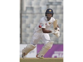 Sri Lanka's captain Dinesh Chandimal plays a shot during the fourth day of their first test cricket match against Bangladesh in Chittagong, Bangladesh, Saturday, Feb. 3, 2018.