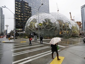 Pedestrians walk past the Amazon Spheres in  Seattle in January during the grand opening of the geodesic domes, which will primarily serve as a working and gathering space for Amazon.com employees.