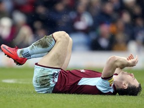 Burnley's Ashley Barnes lies injured during the English Premier League soccer match between Burnley and Manchester City at Turf Moor, in Burnley, England, Saturday Feb. 3, 2018.