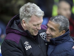 West Ham United manager David Moyes, left and Brighton & Hove Albion manager Chris Hughton hug prior to the English Premier League soccer match between Brighton and West Ham United, at the AMEX Stadium, in Brighton, England,  Saturday, Feb. 3, 2018.