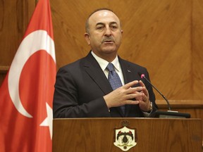 Turkish Foreign Minister Mevlut Cavusoglu at a press conference in Amman, Jordan, Monday, Feb. 19, 2018. Cavusoglu said his country is ready to battle Syrian government troops if they enter an enclave in northern Syria to protect Syrian Kurdish fighters.