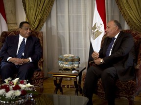 Sudanese Foreign Minister Ibrahim Ghandour, left, meets with his Egyptian counterpart, Sameh Shoukry, at Tahrir Palace, in Cairo, Egypt, Thursday, Feb. 8, 2018.