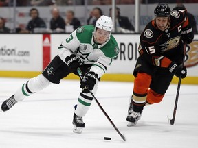 Dallas Stars center Mattias Janmark, left, of Sweden, takes in a pass with Anaheim Ducks center Ryan Getzlaf defending during the first period of an NHL hockey game in Anaheim, Calif., Wednesday, Feb. 21, 2018.