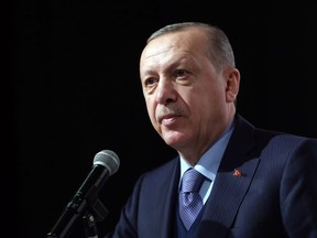 Turkey's President and leader of ruling Justice and Development Party Recep Tayyip Erdogan addresses the party members in Istanbul, Saturday, Feb. 10, 2018. Erdogan has announced that a Turkish military helicopter has been "downed" Saturday in northern Syria during Ankara's offensive on Syrian Kurdish militia there.