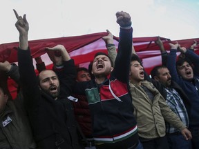 People shout slogans in support of Turkish soldiers during the funeral of Ali Akdogan in Izmir, Turkey, Sunday, Feb. 11, 2018. Akdogan was one of 12 Turkish soldiers killed Saturday during Turkey's Operation Olive Branch against the Syrian Kurdish militia that started on Jan. 20 with Ankara's cross-border incursion into the enclave of Afrin, Syria.