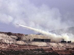 Turkish artillery fires toward Syrian Kurdish positions in Afrin area, Syria, from Turkish side of the border in Hatay, Turkey, Friday, Feb. 9, 2018. Turkish jets have resumed airstrikes in the Syrian Kurdish-run enclave of Afrin after a brief lull killing and wounding several people, the military and media reports said Friday.(AP Photo)