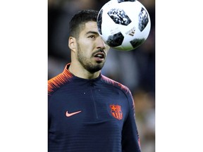 FC Barcelona's Luis Suarez eyes the ball before the Spanish Copa del Rey, semifinal, second leg, soccer match between FC Barcelona and Valencia at the Mestalla stadium in Valencia, Spain, Thursday Feb. 8, 2018.