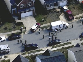 In this image made from video and released by WJLA-TV, authorities work where a police officer was shot, Wednesday, Feb. 21, 2018, in Prince George's County, Md. (WJLA-TV via AP)
