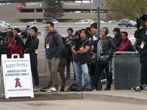 Members of the media await the arrival of Los Angeles Angels baseball player Shohei Ohtani at Tempe Diablo Stadium on Tuesday, Feb. 13, 2018, in Tempe, Ariz.