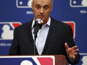 Baseball Commissioner Rob Manfred gestures while speaking during a Major League Baseball owners meeting on Tuesday, Feb. 20, 2018 in Glendale, Ariz.