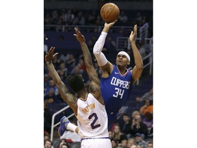 Los Angeles Clippers forward Tobias Harris (34) shoots over the defense of Phoenix Suns' Elfrid Payton during the first half of an NBA basketball game, Friday, Feb. 23, 2018, in Phoenix.