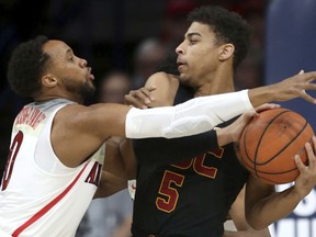 Arizona guard Parker Jackson-Cartwright (0) defends against Southern California guard Derryck Thornton (5) during the first half of an NCAA college basketball game Saturday, Feb. 10, 2018, in Tucson, Ariz.