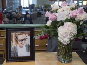 A photograph and a floral arrangement sit in the reception area at the funeral for Rebecca Schofield at Immaculate Heart of Mary Catholic Church in Riverview, N.B. on Wednesday, Feb. 21, 2018.