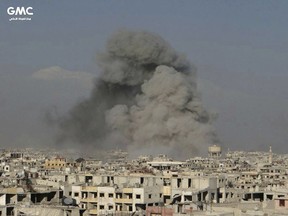 This photo released on Friday, Feb. 23, 2018 by the Syrian anti-government activist group Ghouta Media Center, which has been authenticated based on its contents and other AP reporting, shows smoke rising after Syrian government airstrikes hit Ghouta, suburb of Damascus, Syria. Syrian government warplanes supported by Russia continued their relentless bombardment of the rebel-controlled eastern suburbs of Damascus for a sixth day Friday, killing five people, opposition activists and a war monitor reported. The death toll from the past week climbed to more than 400.