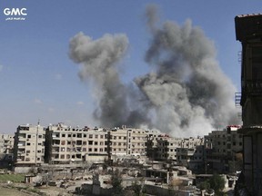 This photo released on Friday, Feb. 23, 2018 by the Syrian anti-government activist group Ghouta Media Center, which has been authenticated based on its contents and other AP reporting, shows smoke rising after Syrian government airstrikes hit Ghouta, suburb of Damascus, Syria. Syrian government warplanes supported by Russia continued their relentless bombardment of the rebel-controlled eastern suburbs of Damascus for a sixth day Friday, killing five people, opposition activists and a war monitor reported. The death toll from the past week climbed to more than 400.