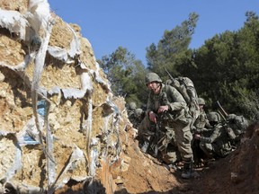 FILE - In this Sunday, Jan. 28, 2018 file photo, Turkish troops try to take control of Bursayah hill, which separates the Kurdish-held enclave of Afrin from the Turkey-controlled town of Azaz, Syria. Syria's Kurdish militia is growing frustrated with its patron, the United States, and is pressing it to do more to stop Turkey's assault on Afrin. Their complaints reflect the differing agendas. The Kurds want to ensure their self-rule, while the U.S. wants them to focus on governing the territory they wrested from IS militants. (AP Photo, File)