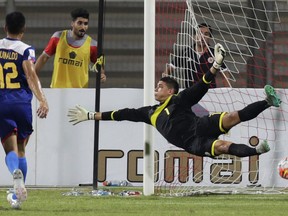 FILE - In this Tuesday, Oct. 13, 2015, file photo, Philippines' goalkeeper Neil Etheridge fails to block a Bahrain goal during a preliminary joint qualifier for the 2018 FIFA World Cup and the 2019 AFC Asian Cup in Riffa, Bahrain. Cardiff City goalkeeper Etheridge may not just become the first southeast Asian to play in the English Premier League later this year, he could also help develop soccer in the Philippines, on and off the field.
