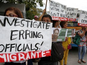 FILE- In this Wednesday, Feb. 21, 2018, file photo, protesters picket the Senate at the start of the probe in the death of an overseas worker in Kuwait in Pasay city, south of Manila, Philippines. The Philippine president says a ban on the deployment of workers to Kuwait, where a Filipina was found dead in a freezer, will continue and could be expanded to other countries where Filipino workers "suffer brutal treatment and human degradation."