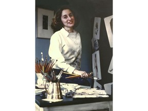 In this 1945 photo provided by the Norman Rockwell Museum, artist Gloria Stoll Karn poses in her New York studio. Karn, a pioneering artist, who had a brief but productive stint as an illustrator of pulp crime and romance magazines during the 1940s, is being celebrated with an exhibition of her works opening Saturday, Feb. 10, 2018 at the Norman Rockwell Museum in Stockbridge, Mass. (Norman Rockwell Museum via AP)
