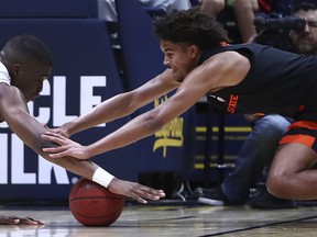 Oregon State's Ethan Thompson, right, and California's Kingsley Okoroh (22) reach for a loose ball in the first half of an NCAA college basketball game Saturday, Feb. 3, 2018, in Berkeley, Calif.