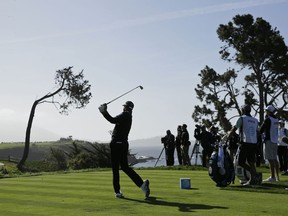 Dustin Johnson hits from the fifth tee of the Pebble Beach Golf Links during the third round of the AT&T Pebble Beach National Pro-Am golf tournament Saturday, Feb. 10, 2018, in Pebble Beach, Calif.