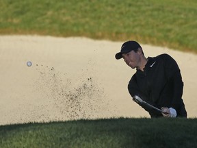 Rory McIlroy, of Northern Ireland, follows his shot out of a bunker up to the 10th green of the Monterey Peninsula Country Club Shore Course during the second round of the AT&T Pebble Beach National Pro-Am golf tournament Friday, Feb. 9, 2018, in Pebble Beach, Calif.