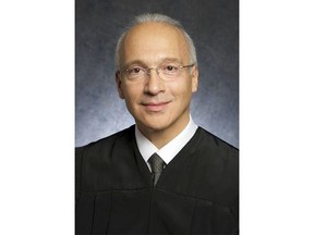 FILE - This undated file photo provided by the U.S. District Court shows Federal Judge Gonzalo Curiel. Curiel was berated by Donald Trump for his handling of lawsuits alleging fraud at now-defunct Trump University. He will hear arguments Friday, Feb. 9, 2018, in a lawsuit that could block construction of a border wall with Mexico, or at least cause major delays.  (U.S. District Court via AP, File)