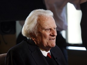 FILE - In this Dec. 20, 2010 file photo, evangelist Billy Graham, 92, speaks during an interview at the Billy Graham Evangelistic Association headquarters in Charlotte, N.C. Graham, who died Wednesday, Feb. 21, 2018, at his home in North Carolina's mountains at age 99, reached hundreds of millions of listeners around the world with his rallies and his pioneering use of television. Graham's body will be brought to his hometown of Charlotte on Saturday, Feb. 24, as part of a procession expected to draw crowds of well-wishers.