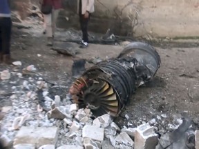 This photo provided by the Ibaa News Agency the media arm of al-Qaida's branch in Syria shows part of a Russian plane that was shot down by rebel fighters over northwest Idlib province in Syria, Saturday, Feb. 3, 2018.  A Russian pilot who ejected from his fighter jet after it was shot down in northwestern Syria on Saturday was killed by militants after he landed alive on the ground and resisted capture by an al-Qaida-linked group, Syrian monitors and a Syrian militant said. Moscow did not confirm the downing of its plane or the killing of a pilot in Syria. The Britain-based Syrian Observatory for Human Rights said the Russian pilot was dead but had no further details.  (Ibaa News Agency via AP)