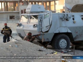 FILE -This photo posted on a file sharing website Wednesday, Jan. 11, 2017, by the Islamic State Group in Sinai, a militant organization, shows a deadly attack by militants on an Egyptian police checkpoint, Monday, Jan. 9, 2017, in el-Arish, north Sinai, Egypt. Arabic reads, "Clash with light arms with the remaining apostates left alive at the fire station checkpoint." Egypt's military says it has begun a major security operation in areas including the restive northern Sinai Peninsula, where Islamic militants are most active. (Islamic State Group in Sinai, via AP, File)