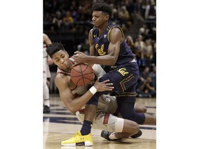 California guard Darius McNeill, top, and Stanford forward KZ Okpala fight for the ball during the first half of an NCAA college basketball game in Berkeley, Sunday, Feb. 18, 2018.