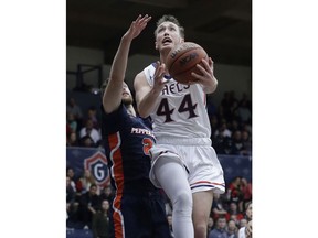 Saint Mary's guard Cullen Neal (44) shoots in front of Pepperdine guard Knox Hellums during the first half of an NCAA college basketball game in Moraga, Calif., Thursday, Feb. 22, 2018.
