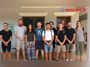 In this photo dated Jan. 27, 2018, issued by Cambodian National Police, a group of foreigners stand after they were arrested for "dancing pornographically" at a party in Siem Reap town, near the country's famed Angkor Wat temple complex.