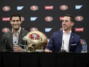 San Francisco 49ers quarterback Jimmy Garoppolo, left, smiles next to head coach Kyle Shanahan during an NFL football press conference Friday, Feb. 9, 2018, in Santa Clara, Calif. Garoppolo has signed a five-year contract with the 49ers worth a record-breaking $137.5 million.