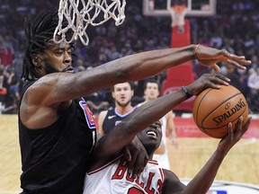 Los Angeles Clippers center DeAndre Jordan, left, blocks the shot of Chicago Bulls guard Jerian Grant during the first half of an NBA basketball game, Saturday, Feb. 3, 2018, in Los Angeles.