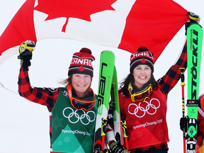 Silver medallist Brittany Phelan and gold medallist Kelsey Serwa of Canada celebrate after the women's ski cross final.