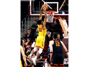 Southern California guard Elijah Stewart, center, goes up for a dunk against Oregon State during the first half of an NCAA college basketball game Saturday, Feb. 17, 2018, in Los Angeles.