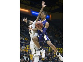 Washington's Hameir Wright, right, drives to the basket against California's Marcus Lee (24) during the first half of an NCAA college basketball game, Saturday, Feb. 24, 2018, in Berkeley, Calif.