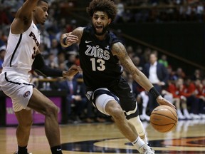 Gonzaga guard Josh Perkins, right, drives against Pacific guard Miles Reynolds during the first half of an NCAA college basketball game Thursday, Feb. 8, 2018, in Stockton, Calif.