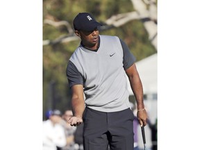Tiger Woods tries to coax a putt on the 14th green during the first round of the Genesis Open golf tournament at Riviera Country Club in the Pacific Palisades neighborhood of Los Angeles on Thursday, Feb. 15, 2018.