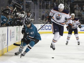 Edmonton Oilers center Leon Draisaitl (29) jumps out of the way from the check by San Jose Sharks defenseman Joakim Ryan (47) during the first period of an NHL hockey game Saturday, Feb. 10, 2018, in San Jose, Calif.