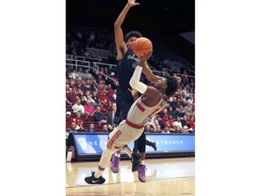 Stanford guard Daejon Davis (1) is fouled by Washington guard Matisse Thybulle (4) during the first half of an NCAA college basketball game Thursday, Feb. 22, 2018, in Stanford, Calif.
