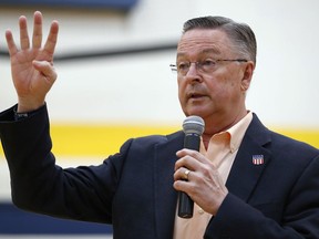 FILE - In this May 11, 2017, file photo, Rep. Rod Blum, R-Iowa, speaks during a town hall meeting in Marshalltown, Iowa. Blum has likely violated multiple House ethics rules by failing to disclose a new company that he founded, using an official photo on its website, and having an aide appear in a false testimonial for its services, a review by The Associated Press shows. Blum, a Republican facing a competitive race for re-election, is one of two directors of the Tin Moon Corporation, a digital marketing company incorporated in 2016 as Blum was in his first term, a business filing shows.