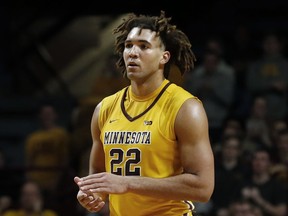 FILE - In this Jan. 3, 2018, file photo, Minnesota center Reggie Lynch plays against Illinois during an NCAA college basketball game in Minneapolis. An attorney for Lynch said Thursday, Feb. 15, 2018, the senior center is dropping his appeal of sexual assault allegations but still maintains his innocence. The university's Equal Opportunity and Affirmative Action office recommended Lynch's suspension and expulsion in January after finding him responsible for the alleged sexual assaults of two women in April 2016.