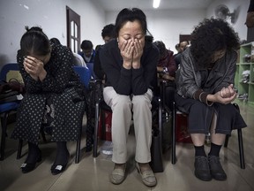 Chinese Christians pray during a service at an underground independent Protestant church on Oct. 12, 2014, in Beijing.