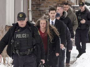 Forensic Anthropologist Professor Kathy Gruspier (second left) is seen on Thursday, February 8, 2018, with Police officers at a Toronto property where alleged serial killer Bruce McArthur worked.